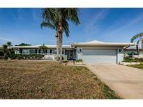 Charming single-story home with well-maintained landscaping and a two-car garage on a sunny day at 4704 Shale Pl, Tampa, FL 33615