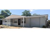 Charming single-story home with a covered porch and attached one-car garage at 5122 Dove Dr, New Port Richey, FL 34652