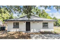 Charming single-story home featuring updated paint, landscaping and exterior lighting at 8107 N 11Th St, Tampa, FL 33604