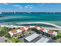 Stunning aerial view of a beachfront condo complex with beautiful ocean views and ample parking at 865 S Gulfview Blvd # 308, Clearwater, FL 33767