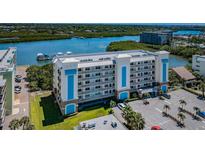 Exterior view of condo building showcasing its architecture, balconies, and waterfront location at 19519 Gulf Blvd # 203, Indian Shores, FL 33785