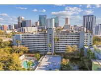 Charming condo building with a community pool and stunning city views in the background at 201 W Laurel St # 704, Tampa, FL 33602