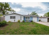 Charming single-story home with stone facade and a well-maintained front lawn and attached garage at 4545 Annette St, New Port Richey, FL 34652