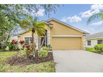 Charming single-story home with a well-manicured lawn and vibrant landscaping at 5205 Lansdowne Way, Palmetto, FL 34221