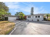 Charming single-story home featuring a well-maintained lawn, attached garage, and freshly painted exterior at 6811 N Himes Ave, Tampa, FL 33614