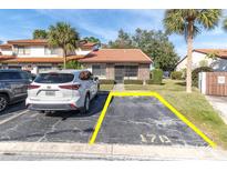 Charming single-story home with a red tile roof, palm trees and dedicated parking at 7360 Ulmerton Rd # 17D, Largo, FL 33771