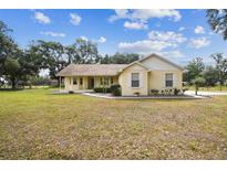 Charming single-story home with a well-maintained lawn and inviting curb appeal on a sunny day at 1202 Williams Rd, Plant City, FL 33565