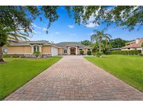 Charming home featuring a brick driveway, well-manicured lawn and beautiful landscaping at 19815 Sea Rider Way, Lutz, FL 33559