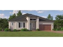 Charming single-story home with a symmetrical facade, a two-car garage, and lush landscaping at 31670 Cannon Rush Dr, San Antonio, FL 33576
