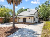 Charming home featuring a concrete driveway, well-maintained landscaping, and inviting front porch at 3316 W Napoleon Ave, Tampa, FL 33611