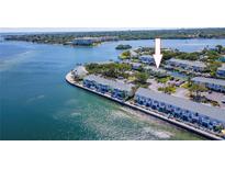 Waterfront condos featuring coastal living with boat docks and lush landscaping on a sunny day at 5225 Coquina Key Se Dr # B, St Petersburg, FL 33705