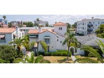 Charming Mediterranean-style home with a red tile roof and lush tropical landscaping at 53 Albemarle Ave, Tampa, FL 33606