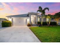 Beautiful single Gathering home featuring a landscaped yard, well-lit entry, and a two-car garage at 6121 33Rd N Ave, St Petersburg, FL 33710