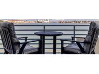 Inviting waterfront balcony with table and chairs offering serene coastal views at 7922 Sailboat Key S Blvd # 105, South Pasadena, FL 33707