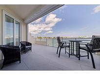Outdoor patio area with furniture and a beautiful water view at 7922 Sailboat Key S Blvd # 105, South Pasadena, FL 33707