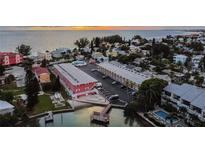 Stunning aerial view showcases the property's prime waterfront location, pool, and surrounding neighborhood at 8565 W Gulf Blvd # 21S, St Petersburg, FL 33706