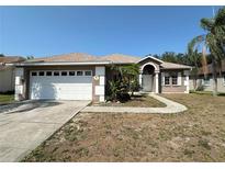 Charming single Gathering home with arched entryway and two-car garage at 1145 Riveredge Dr, Tarpon Springs, FL 34689