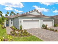 Charming single-story home boasts a well-manicured lawn, paved driveway, and a convenient two-car garage at 20417 Symphony Pl, Venice, FL 34293