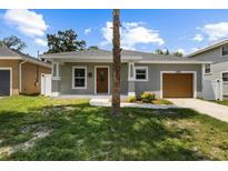 Charming single-story home featuring a well-maintained lawn and an attached one car garage at 2906 E Columbus Dr, Tampa, FL 33605