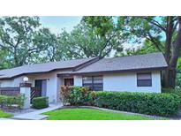 Charming single-story home featuring a well-maintained lawn and mature trees at 2910 Star Apple Ct, Palm Harbor, FL 34684