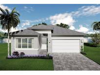 Charming single-story home with a paver driveway and lush landscaping at 3546 Malta Ave, Wesley Chapel, FL 33543