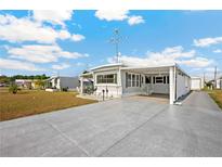 Charming single-story home with a covered carport and well-maintained landscaping in a quiet community at 5251 Flint St, Zephyrhills, FL 33542