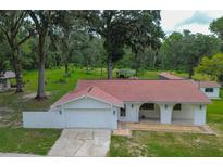 Charming single-story home with a two-car garage and front porch at 6234 Neff Lake Rd, Brooksville, FL 34601