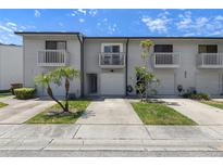 Charming townhome with small trees, driveways, balconies, and a well-maintained facade at 6420 92Nd N Pl # 1205, Pinellas Park, FL 33782