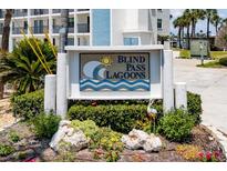 Sign for Blind Pass Lagoons community with landscaping and palm trees at 9815 Harrell Ave # 503, Treasure Island, FL 33706