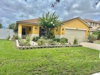 Charming single-Gathering home featuring a well-maintained lawn and beautiful landscaping at 10607 Boyette Creek Blvd, Riverview, FL 33569