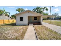 Charming single-story home featuring a covered front porch and carport at 1108 E Annie St, Tampa, FL 33612