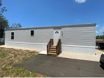 Charming single-story home featuring a freshly painted exterior and a newly built wood staircase at 11351 Edison Ave, New Port Richey, FL 34654