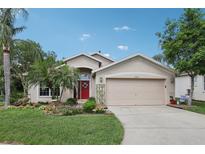 Charming single-Gathering home featuring a vibrant front yard, manicured lawn and a two-car garage at 13813 Sigler St, Riverview, FL 33579