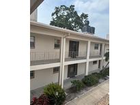 A two-story condo building featuring balconies and well-maintained landscaping at 19029 Us Highway 19 N # 2-23, Clearwater, FL 33764