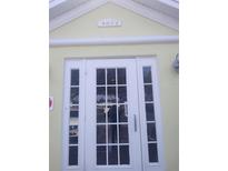 Inviting white-framed front door with glass panels and transom, providing ample natural light into the home at 4872 Beach Se Dr # D, St Petersburg, FL 33705
