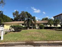 Charming single-story home with a well-maintained lawn and lush landscaping, offering great curb appeal and a welcoming atmosphere at 5029 W Dickens Ave, Tampa, FL 33629