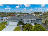 Stunning single-story home boasts meticulous landscaping and an attached two-car garage at 5193 Boyle Ter, Port Charlotte, FL 33981