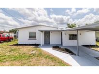 Charming white house featuring a covered entrance and well-manicured lawn at 5210 S 80Th St, Tampa, FL 33619