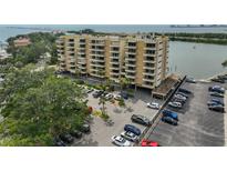 An exterior of the condo building showcasing a parking area and nearby waterway and some water views at 5701 Mariner St # 701, Tampa, FL 33609