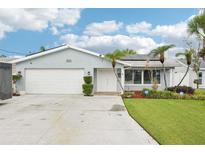 Charming single-story home with a well-maintained front yard, mature palms, and a two-car garage at 6010 Bayou Grande Ne Blvd, St Petersburg, FL 33703