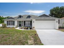 Charming single-story home with a two-car garage and dormer windows at 10101 Langan St, Spring Hill, FL 34608