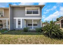 Charming two-story home featuring a covered porch and gray exterior paint at 2048 Los Lomas Dr, Clearwater, FL 33763
