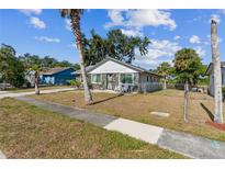 Charming single story home with a manicured front yard and mature palm trees at 2308 18Th E St, Bradenton, FL 34208