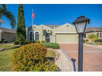 Charming home featuring a manicured lawn and a brick driveway at 445 Noble Faire Dr, Sun City Center, FL 33573