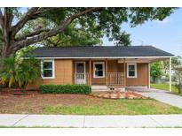 Charming single-story home with covered porch, mature trees, and a cozy, inviting curb appeal at 5042 8Th St, Zephyrhills, FL 33542