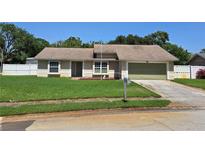 Charming single-story home with a well-maintained lawn and attached garage, offering great curb appeal at 827 Creekside Ln, Palm Harbor, FL 34684