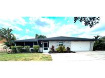 Charming single story home with stone accents, a screened porch, and attached one car garage at 916 Shangri La Dr, Seffner, FL 33584