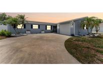 Charming single-story home with a well-manicured lawn and a spacious driveway at 10710 Donbrese Ave, Tampa, FL 33615