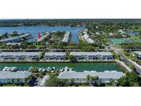 Scenic aerial view of waterfront condos with boat docks on a sunny day at 5075 Starfish Se Dr # A, St Petersburg, FL 33705
