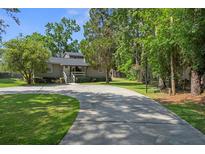 Charming home with a long driveway and mature trees surrounding the property for added privacy at 6501 Barcellona Rd, Land O Lakes, FL 34637